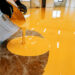 a person pouring liquid into a bucket on an orange 2023 12 20 22 40 09 utc 1 scaled