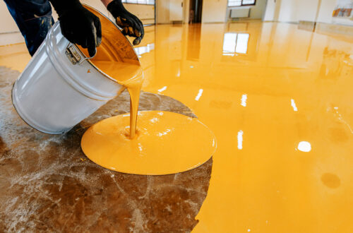 a person pouring liquid into a bucket on an orange 2023 12 20 22 40 09 utc 1 scaled